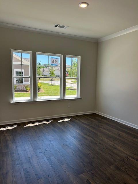 3706 Cheswolde Ave Unit 96, Powder Springs, GA 30127 - empty room featuring crown molding, dark wood-style floors, healthy amount of natural light, baseboards, and recessed lighting