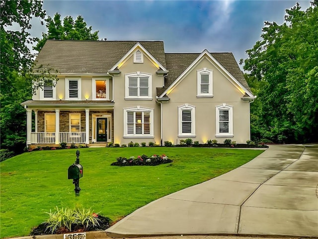 365 Morning Dew Cir, Roswell, GA 30075 - traditional-style home featuring a porch, stucco siding, a front lawn, stone siding, and a shingled roof