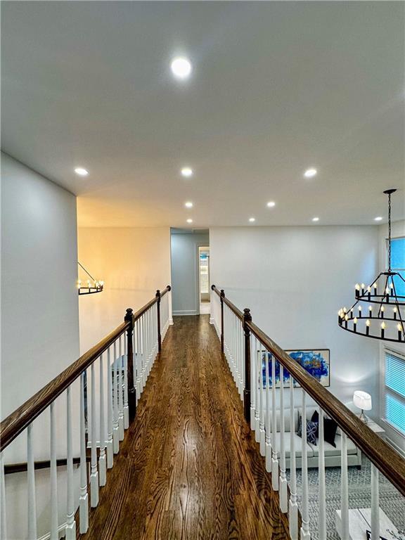 365 Morning Dew Cir, Roswell, GA 30075 - corridor with wood finished floors, a chandelier, recessed lighting, and baseboards