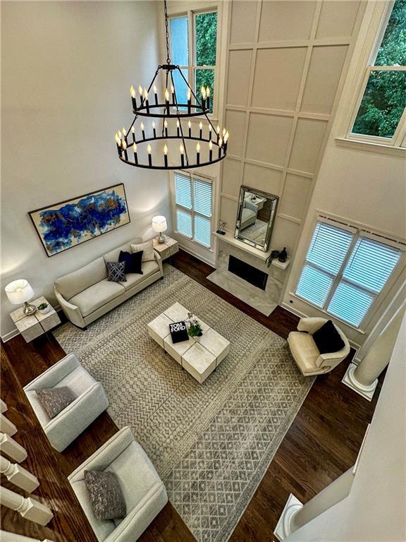 365 Morning Dew Cir, Roswell, GA 30075 - living room with wood finished floors, a chandelier, and plenty of natural light