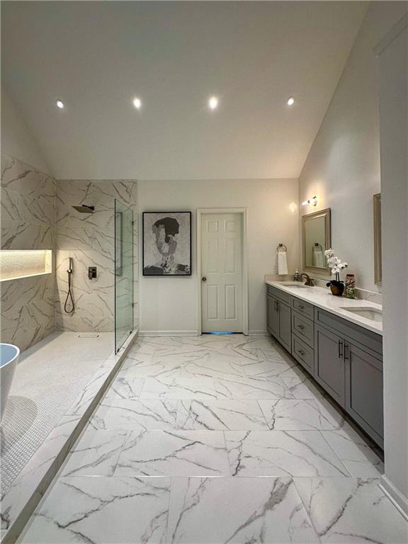 365 Morning Dew Cir, Roswell, GA 30075 - bathroom with lofted ceiling, marble look tiles, a marble finish shower, double vanity, and recessed lighting