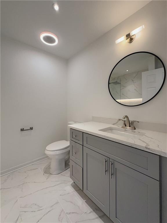 365 Morning Dew Cir, Roswell, GA 30075 - bathroom with vanity, marble look tile flooring, and toilet