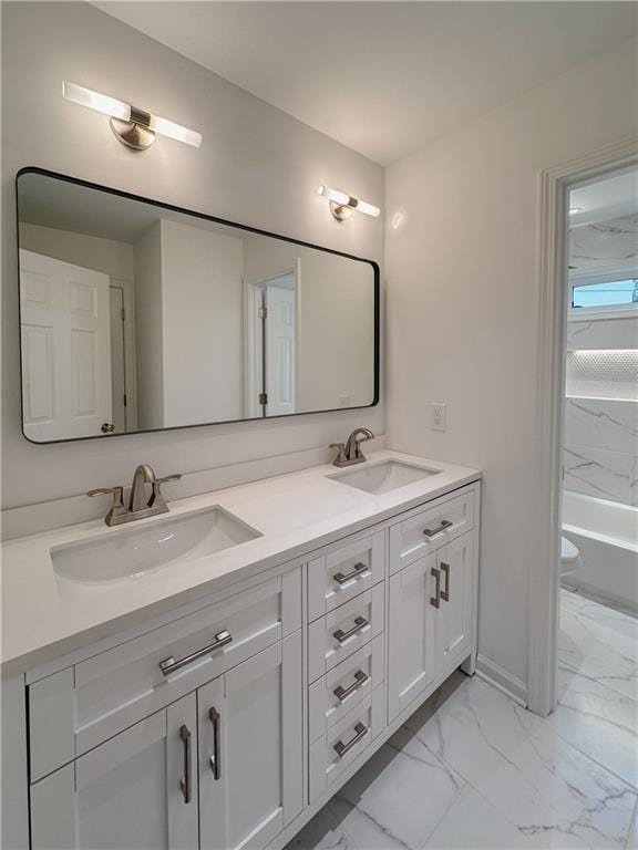 365 Morning Dew Cir, Roswell, GA 30075 - full bathroom with marble look tiles, double vanity, a tub, baseboards, and toilet