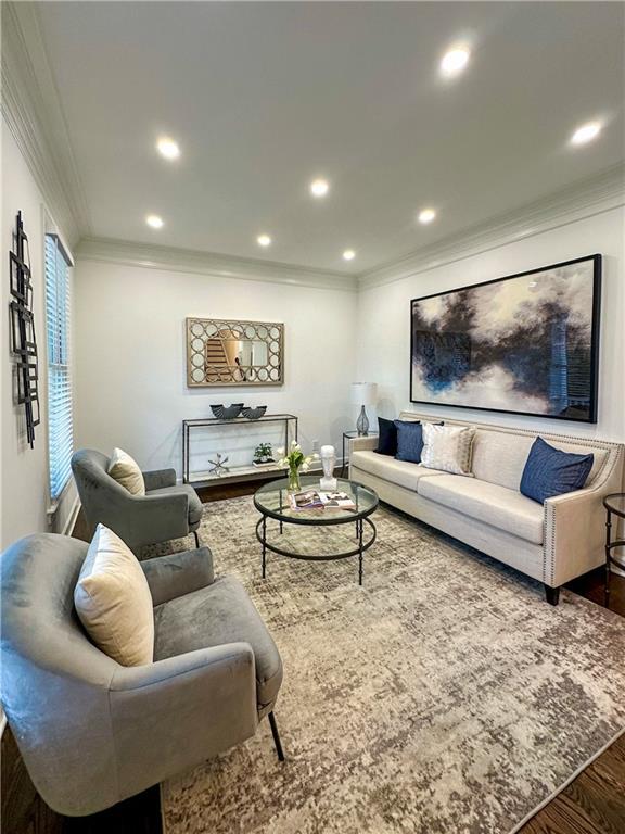 365 Morning Dew Cir, Roswell, GA 30075 - living area with a towering ceiling, arched walkways, wood finished floors, baseboards, and a high end fireplace