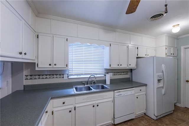 kitchen featuring white appliances, a sink, white cabinets, dark countertops, and tasteful backsplash