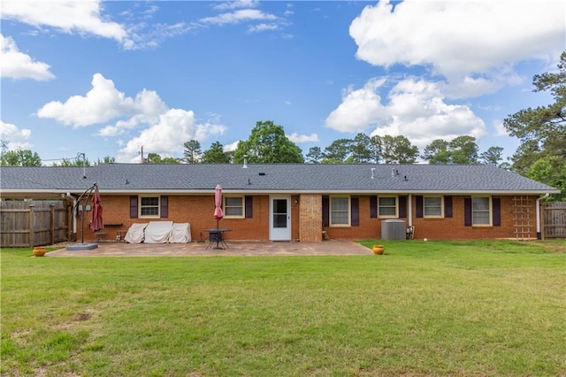 rear view of property with a patio, cooling unit, and brick siding