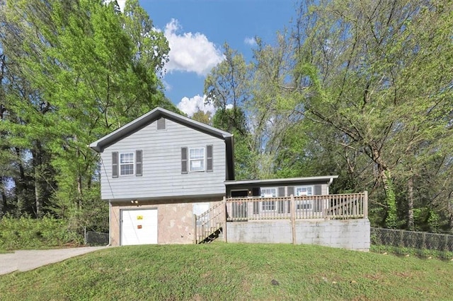 view of front of home featuring a garage and a front lawn