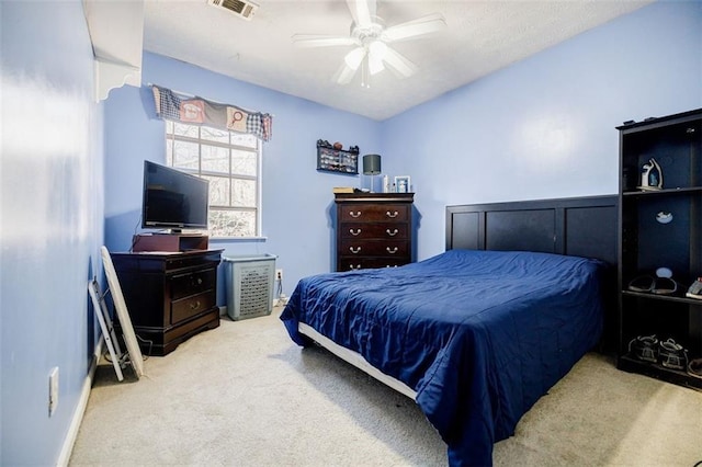 bedroom featuring light colored carpet and ceiling fan