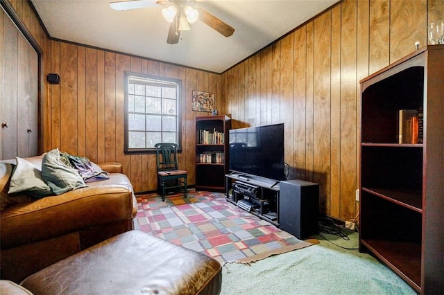 living room featuring ceiling fan and wood walls