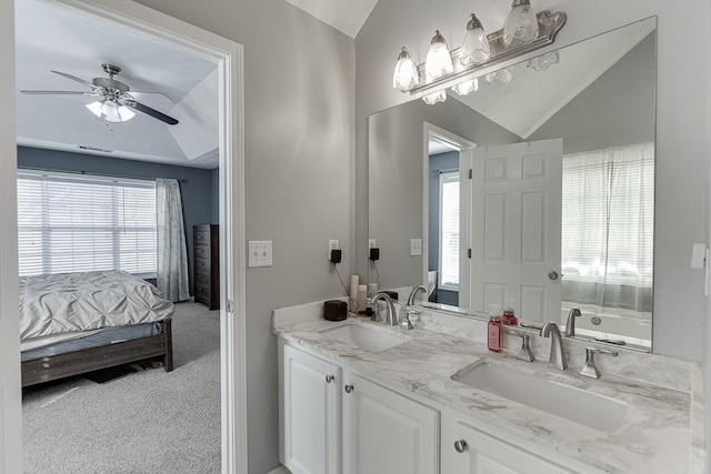 bathroom with vanity, vaulted ceiling, and ceiling fan