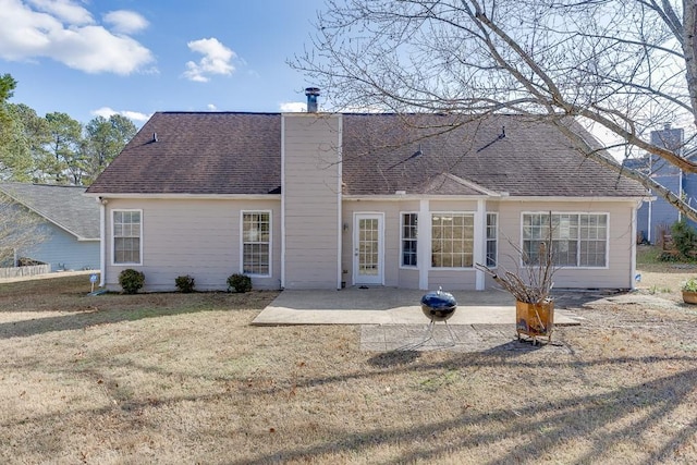 rear view of property featuring a patio area and a yard