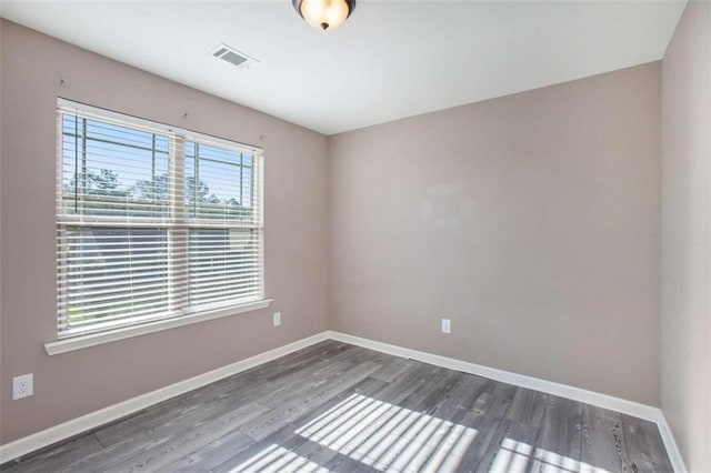 unfurnished room featuring dark hardwood / wood-style floors