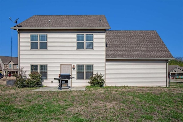 rear view of property featuring a patio and a yard