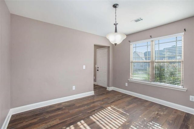 spare room with dark wood-type flooring