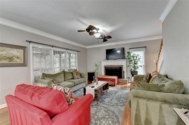 living room with ceiling fan, hardwood / wood-style flooring, crown molding, and a healthy amount of sunlight