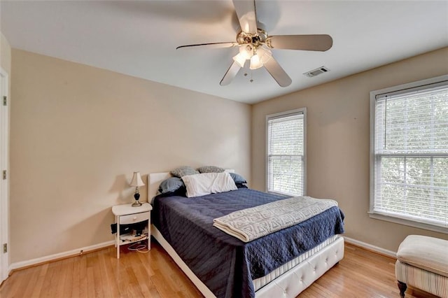 bedroom with ceiling fan and light hardwood / wood-style floors