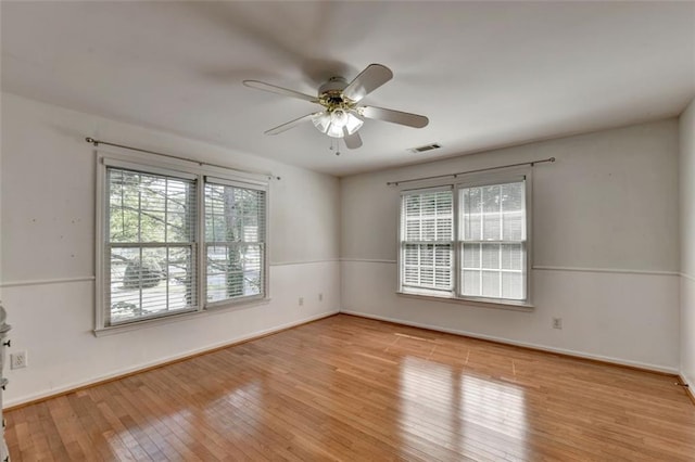 empty room with light hardwood / wood-style flooring and ceiling fan