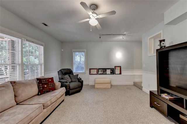 living room with light colored carpet, ceiling fan, and track lighting