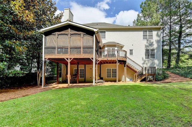 back of house featuring a lawn and a deck