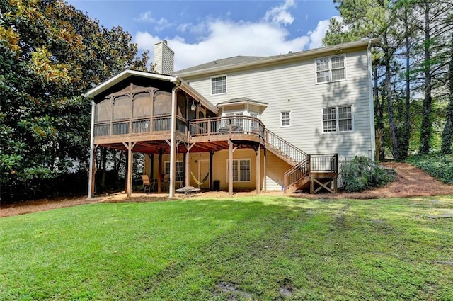 rear view of house with a wooden deck, a yard, and a sunroom