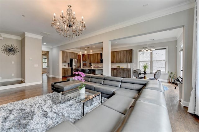 living room featuring a chandelier, plenty of natural light, baseboards, and dark wood-style flooring
