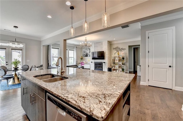 kitchen with a kitchen island with sink, dishwasher, a sink, and dark wood-type flooring