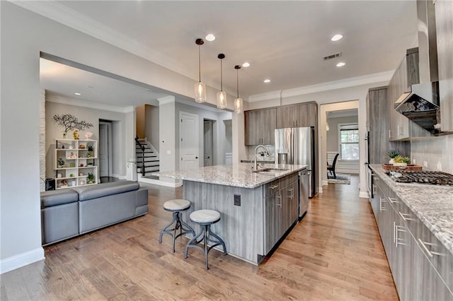 kitchen with modern cabinets, stainless steel appliances, and ornamental molding