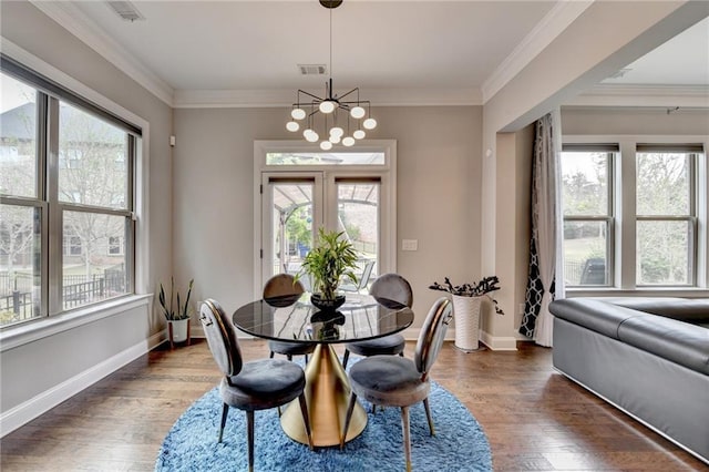 dining area with wood finished floors, visible vents, and plenty of natural light