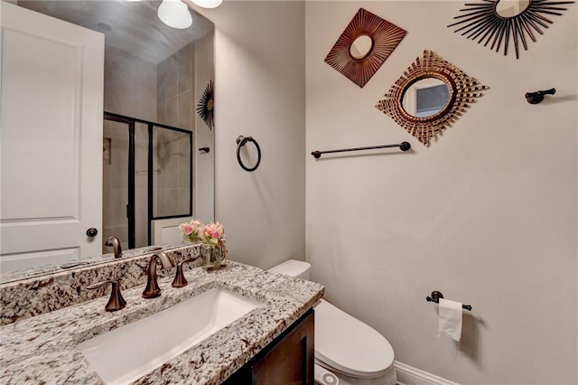 full bath with vanity, a shower stall, and toilet