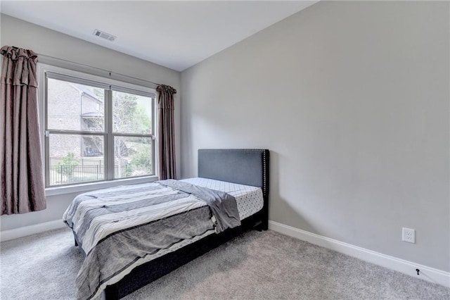 bedroom featuring visible vents, carpet flooring, and baseboards