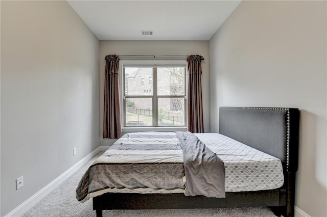 bedroom featuring visible vents, baseboards, and carpet floors