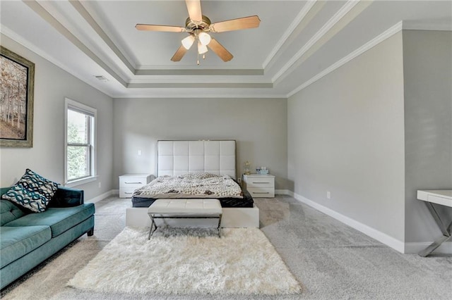 carpeted bedroom featuring a tray ceiling, visible vents, ornamental molding, baseboards, and ceiling fan
