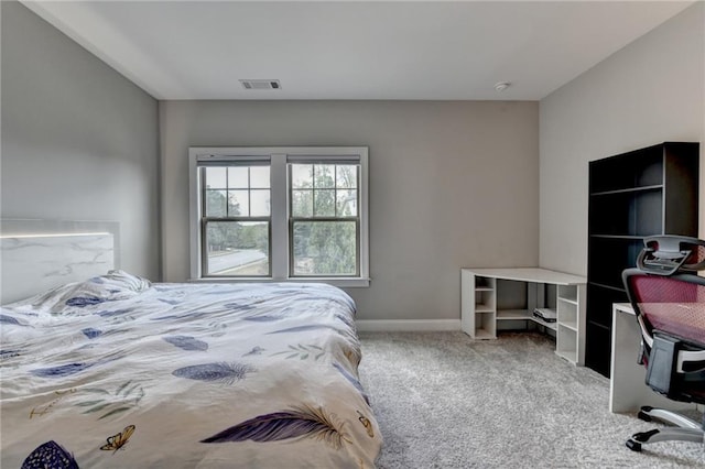 bedroom with carpet floors, visible vents, and baseboards