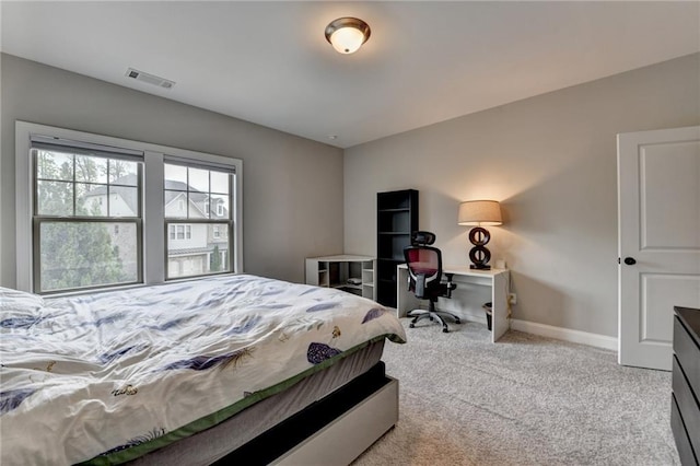 carpeted bedroom featuring baseboards and visible vents