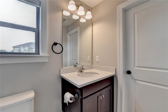 bathroom featuring toilet and vanity