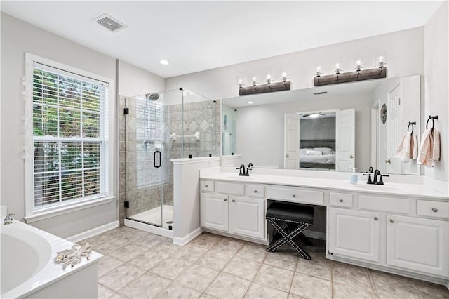 ensuite bathroom with double vanity, a sink, visible vents, and a shower stall