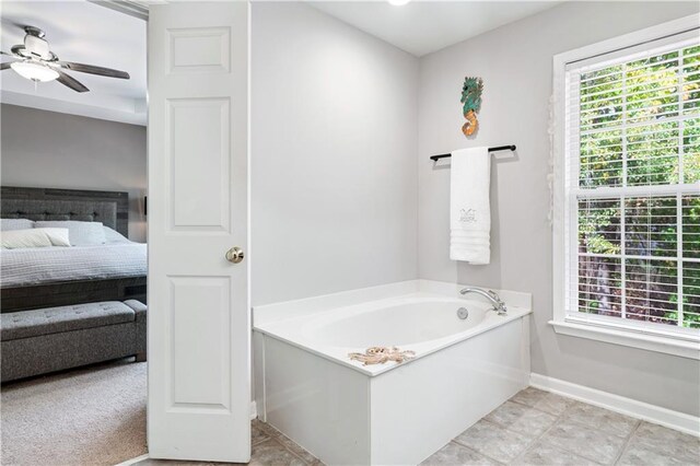 ensuite bathroom featuring baseboards, a ceiling fan, ensuite bath, a garden tub, and tile patterned flooring