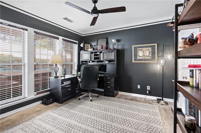 home office featuring ornamental molding, visible vents, baseboards, and wood finished floors