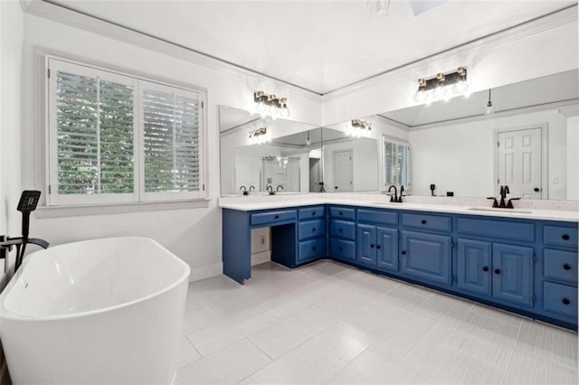 bathroom with a soaking tub, ornamental molding, double vanity, and a sink