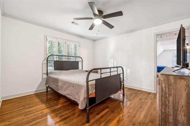 bedroom featuring a ceiling fan, wood finished floors, baseboards, and ornamental molding