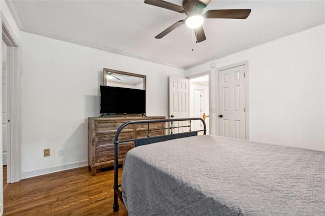 bedroom featuring crown molding, wood finished floors, baseboards, and ceiling fan