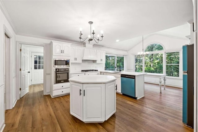 kitchen featuring a notable chandelier, wall oven, dishwasher, and a center island