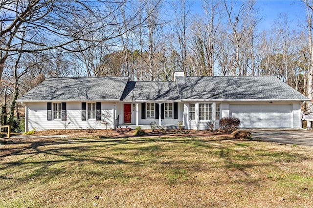 ranch-style home with a garage and a front lawn