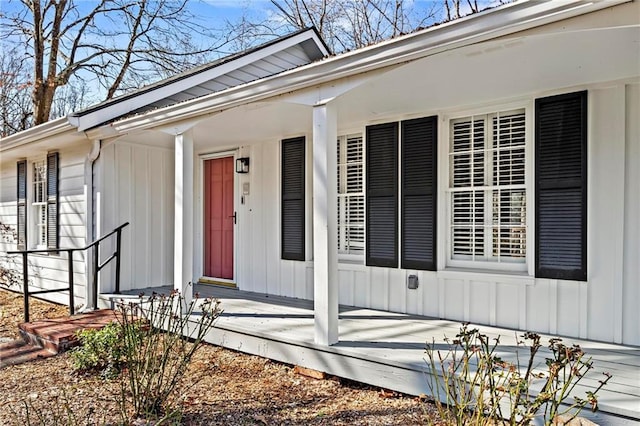 view of exterior entry featuring covered porch