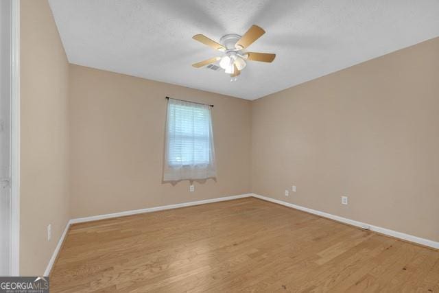 33 Russell Rd, Mcdonough, GA 30252 - unfurnished room featuring light wood finished floors and a ceiling fan