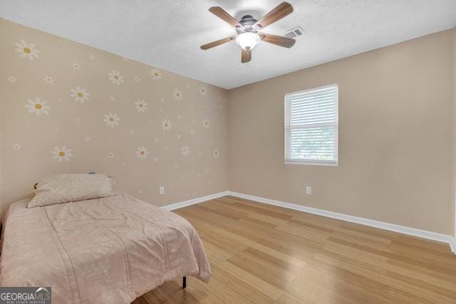 33 Russell Rd, Mcdonough, GA 30252 - bedroom with wallpapered walls, light wood-style floors, and ceiling fan