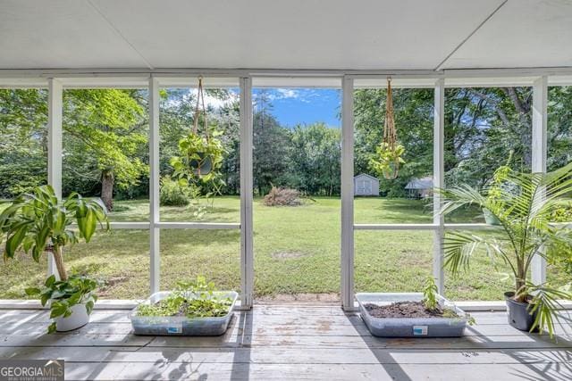 33 Russell Rd, Mcdonough, GA 30252 - sunroom with a deck, expansive windows, and view of scattered trees