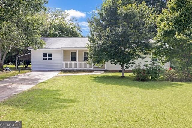 33 Russell Rd, Mcdonough, GA 30252 - view of front facade with a front yard, covered porch, concrete driveway, and a carport