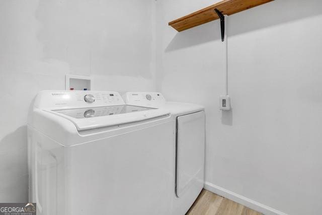 33 Russell Rd, Mcdonough, GA 30252 - laundry area featuring separate washer and dryer and light wood-type flooring
