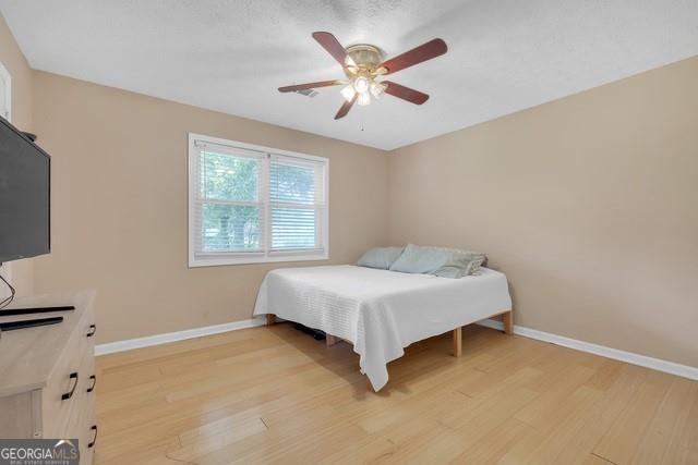 33 Russell Rd, Mcdonough, GA 30252 - bedroom featuring light wood-type flooring and ceiling fan
